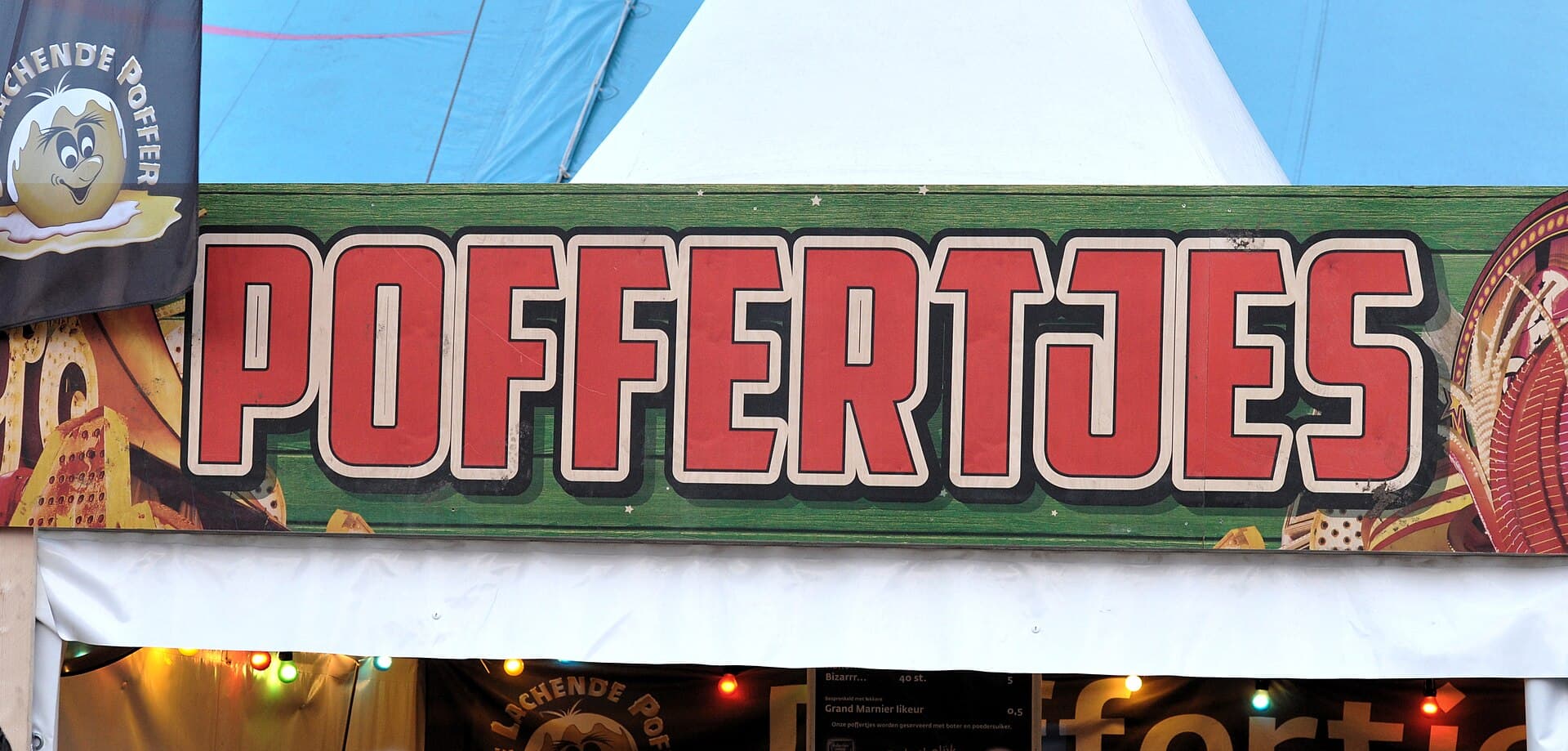 Festival crowd in raincoats and ponchos at a Paaspop stage in April