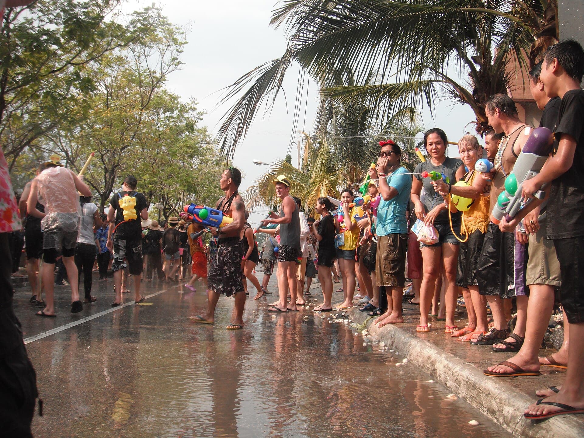 People throwing buckets of water along the Chiang Mai Old City moat during Songkran