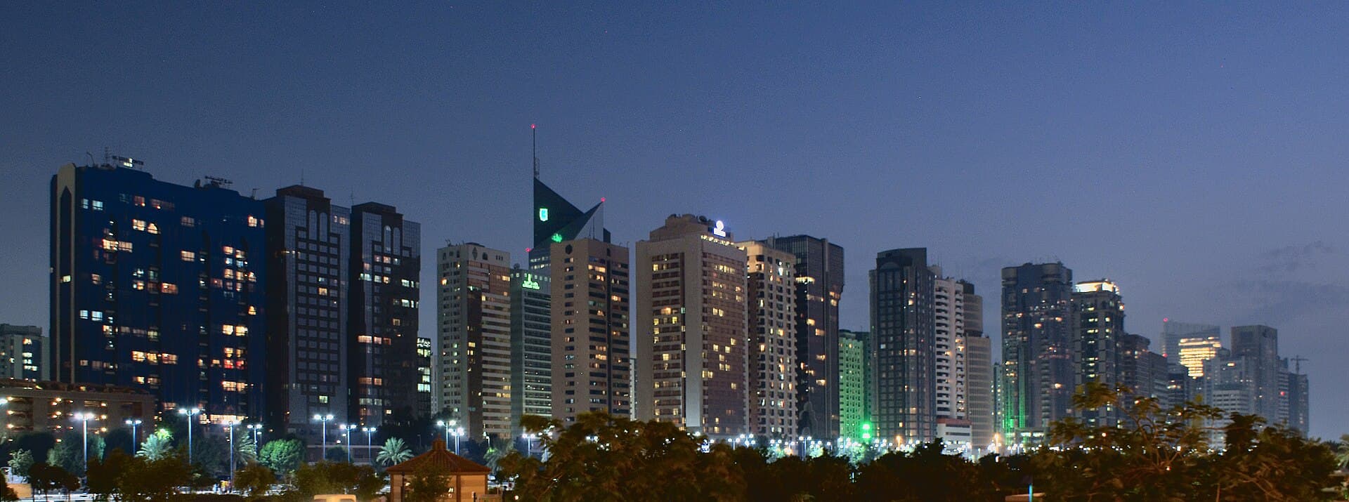Abu Dhabi city skyline along the Corniche at dusk