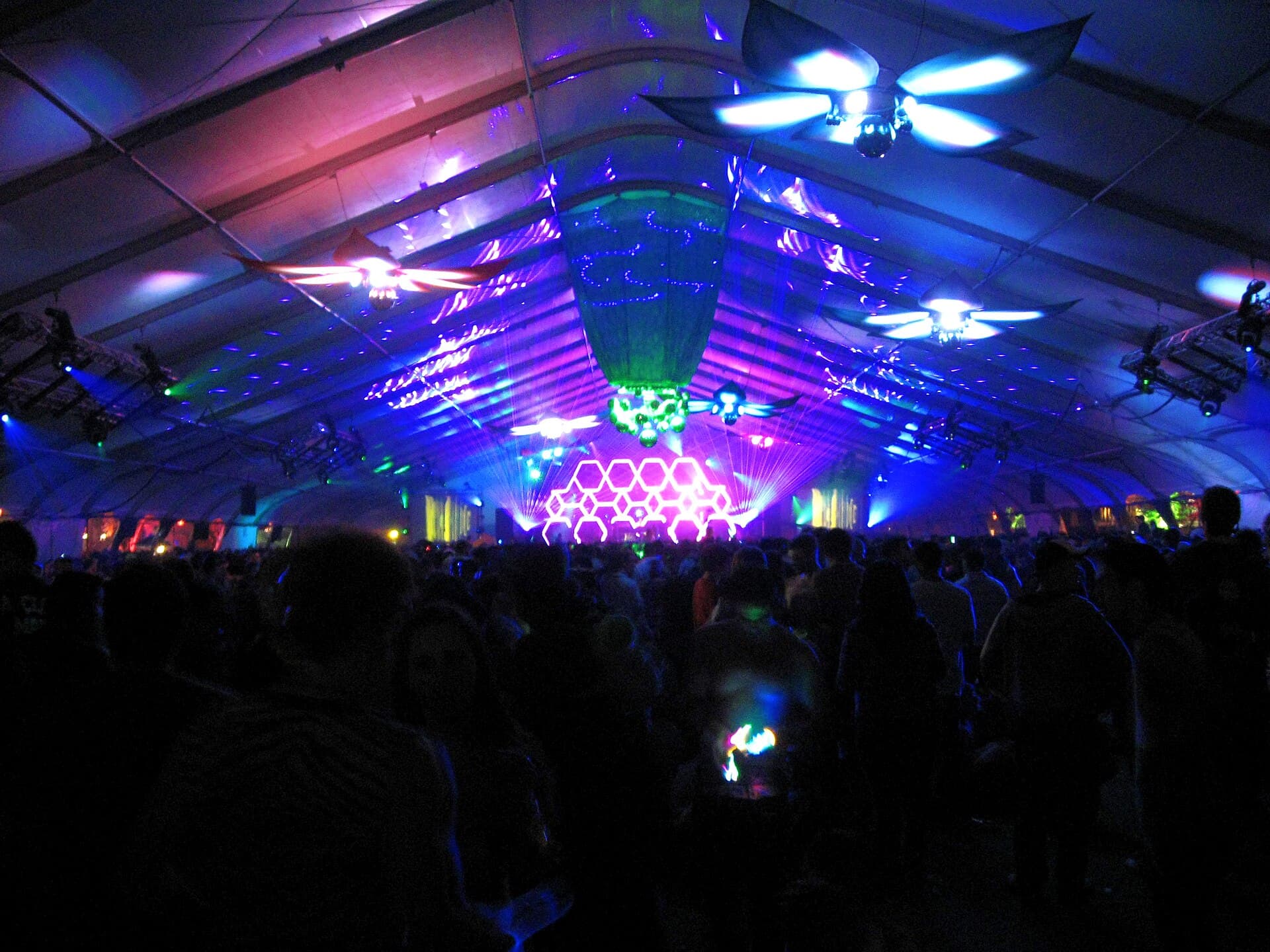 Crowd with LED hoops and glowing costumes dancing at Beyond Wonderland