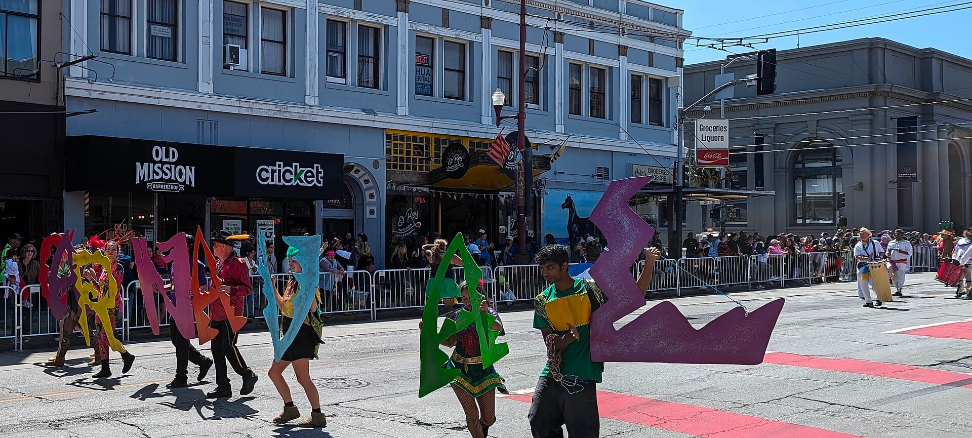 A bloco crowd moving down a street in Centro with a sound truck