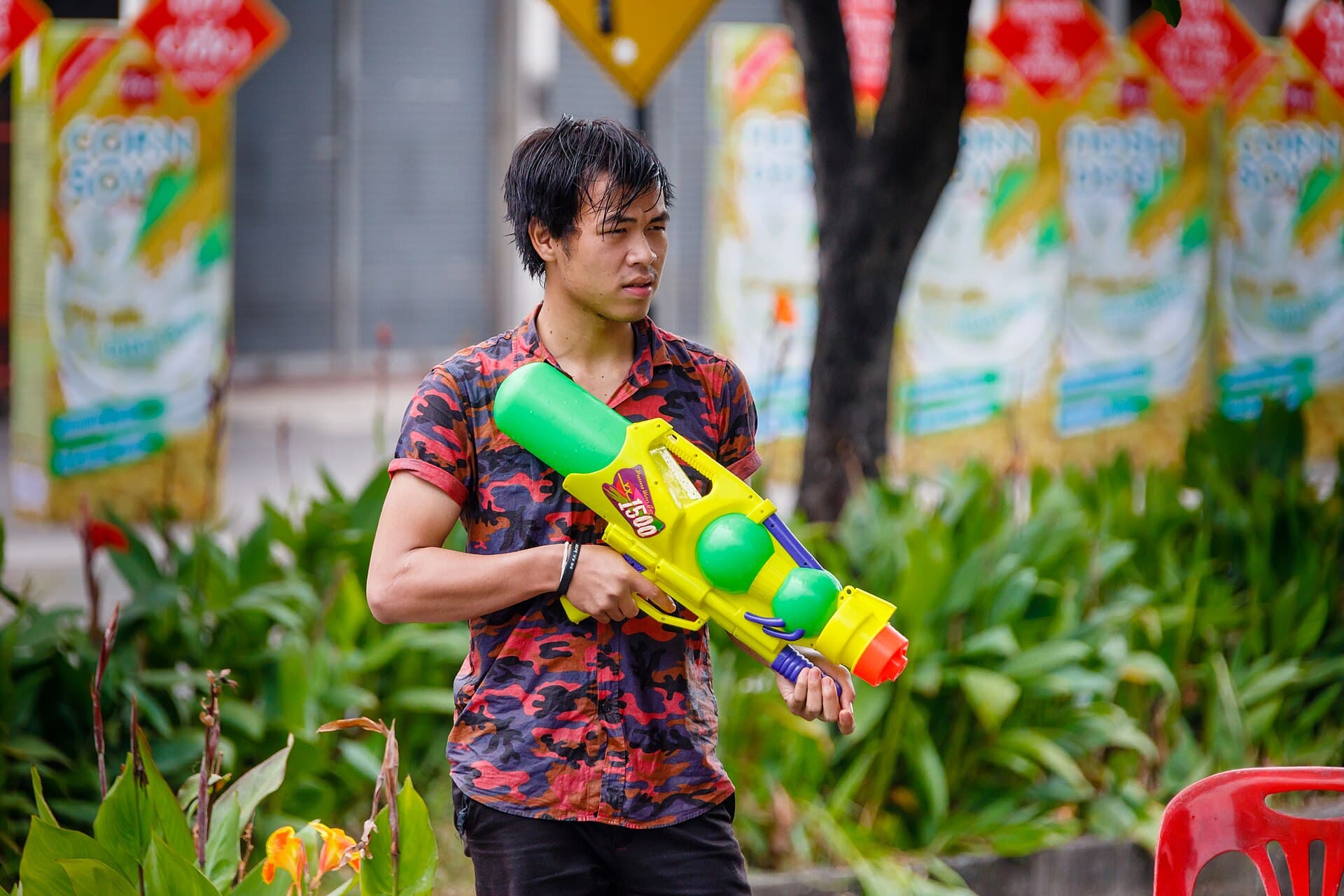 Tha Phae Gate brick walls in Chiang Mai with crowds splashing water on Songkran Day