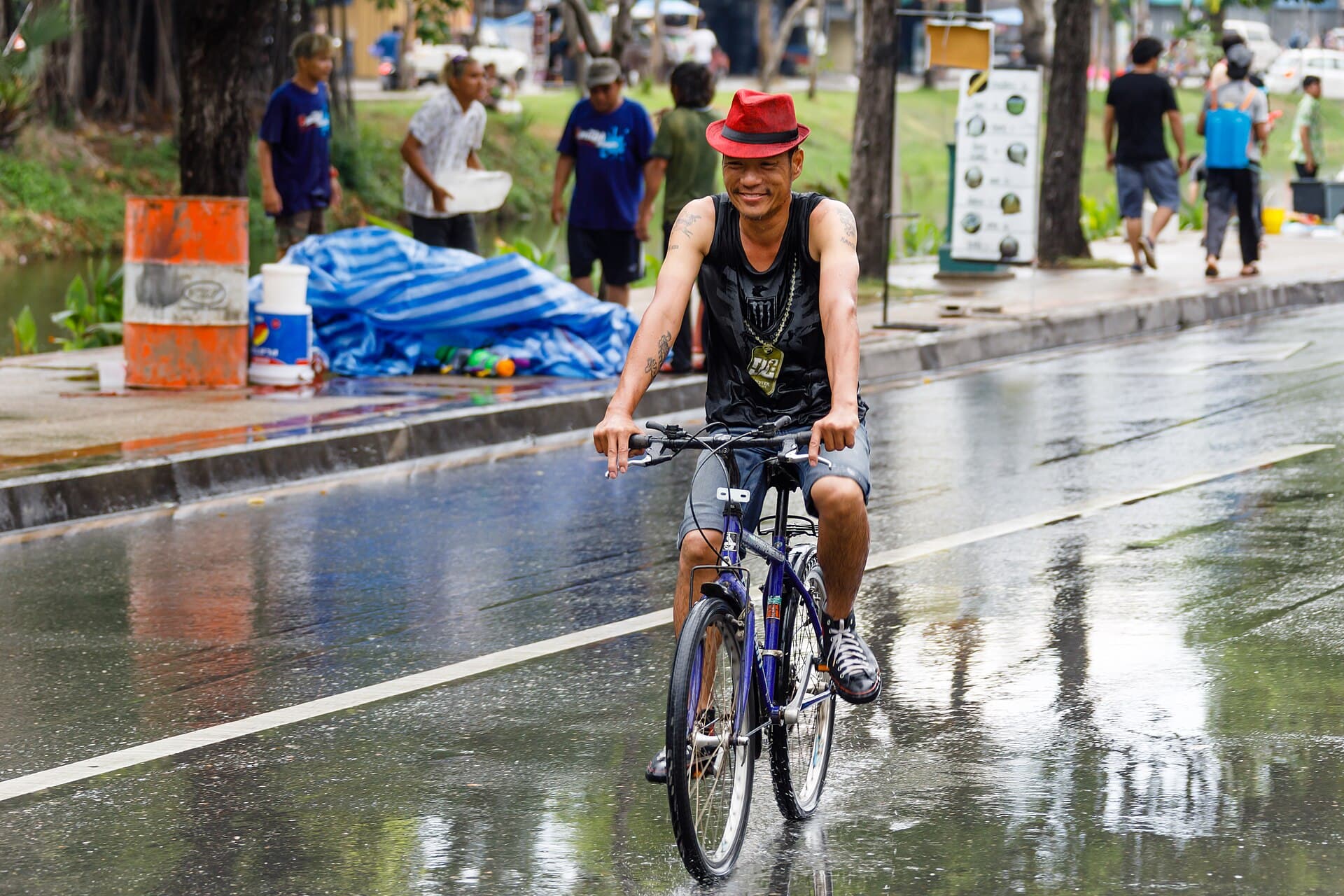 People pouring water on Buddha images carried in the Songkran procession on Tha Phae Road, Chiang Mai