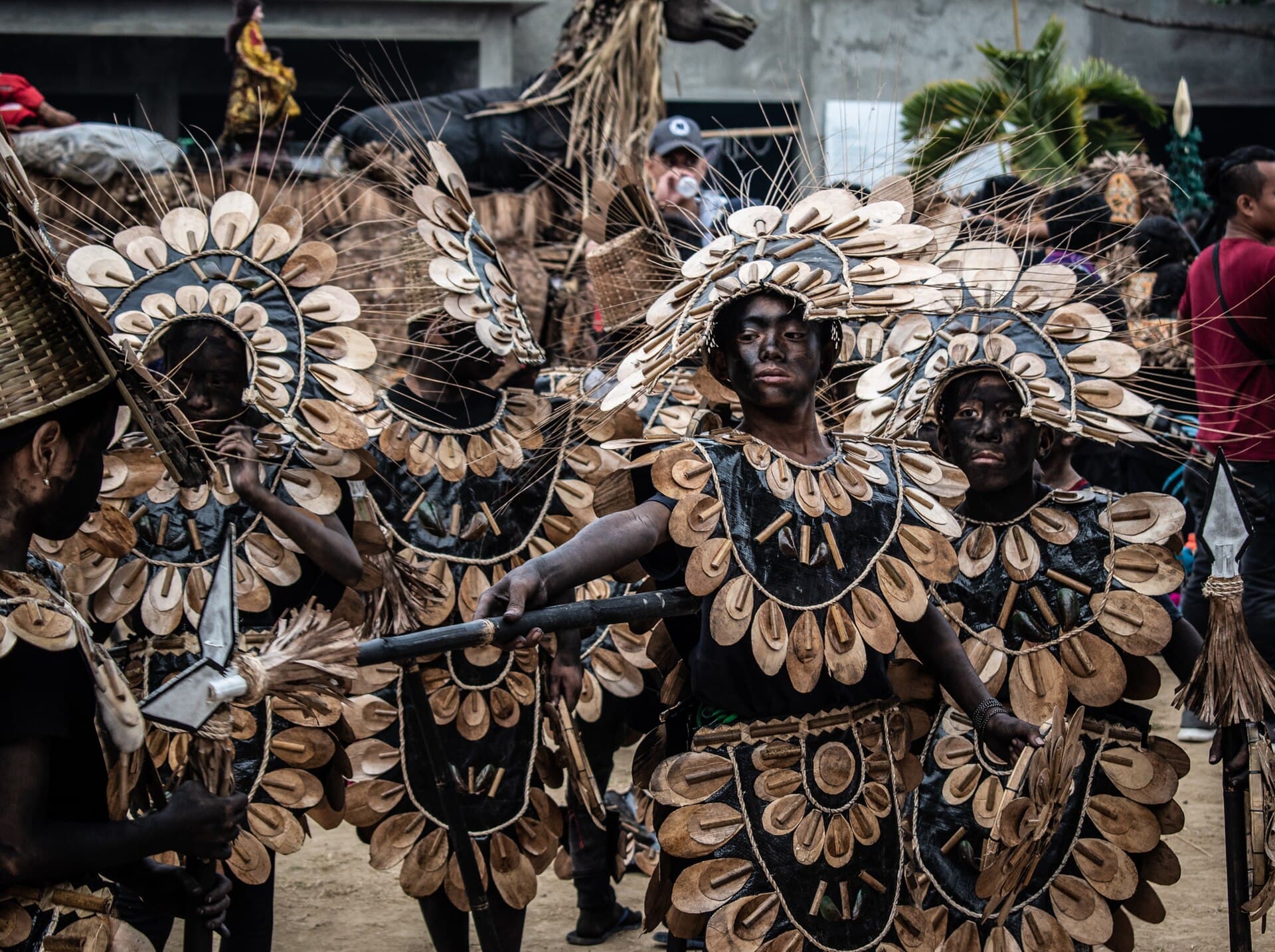 Children in colourful Ati-Atihan costumes dancing on a Kalibo road