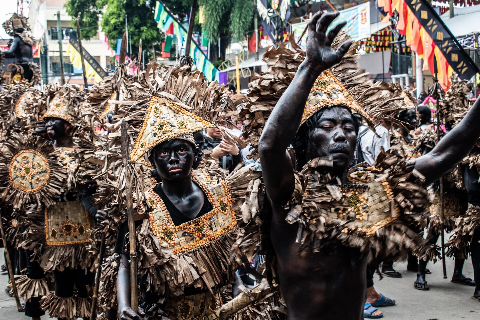 Drummers of a street band leading a tribe through Kalibo at midday