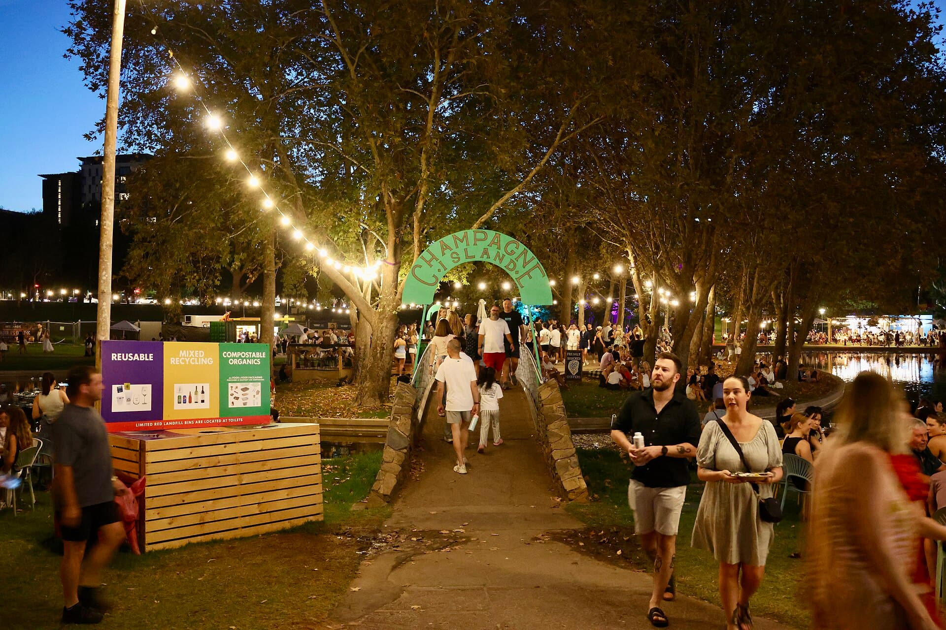 Food stalls and string lights in the Gluttony markets in the evening