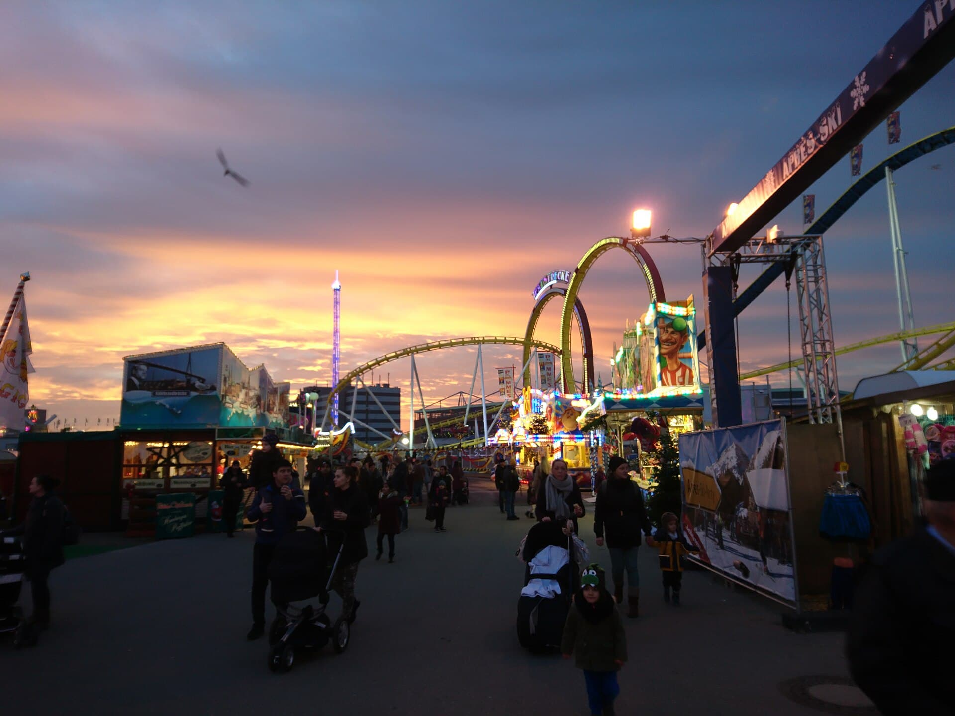The Winterdom fairground lit by Christmas lights with snow on the Heiligengeistfeld