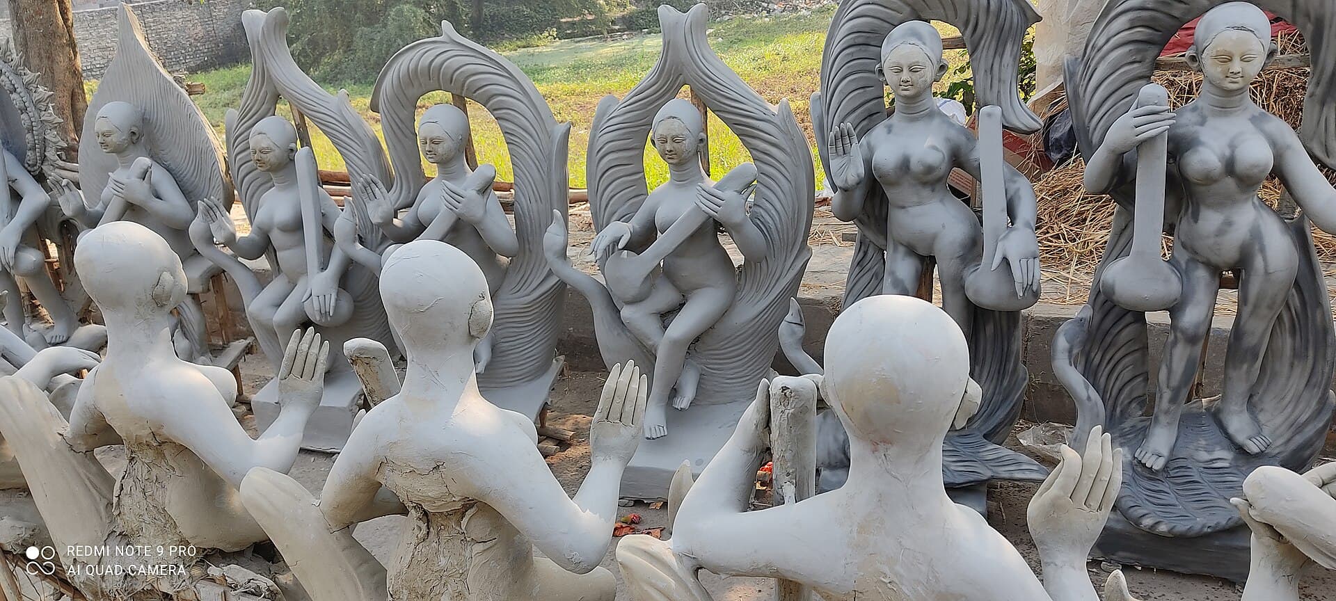 Wide view of Saraswati idols lined up for sale in a Kumartuli lane, Kolkata, before Saraswati Puja