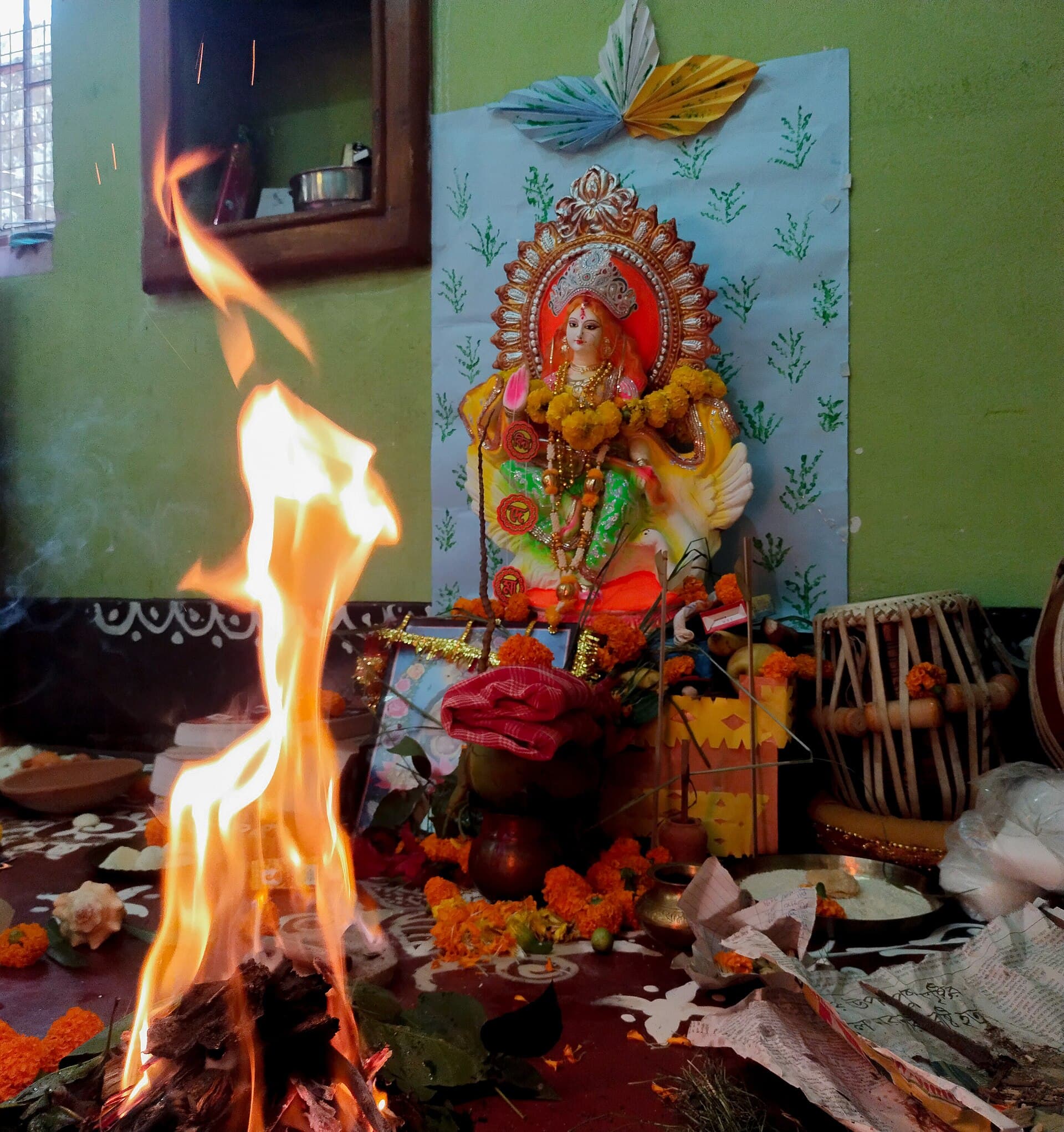 School books, pens and a harmonium placed before a Saraswati idol at a Kolkata home puja