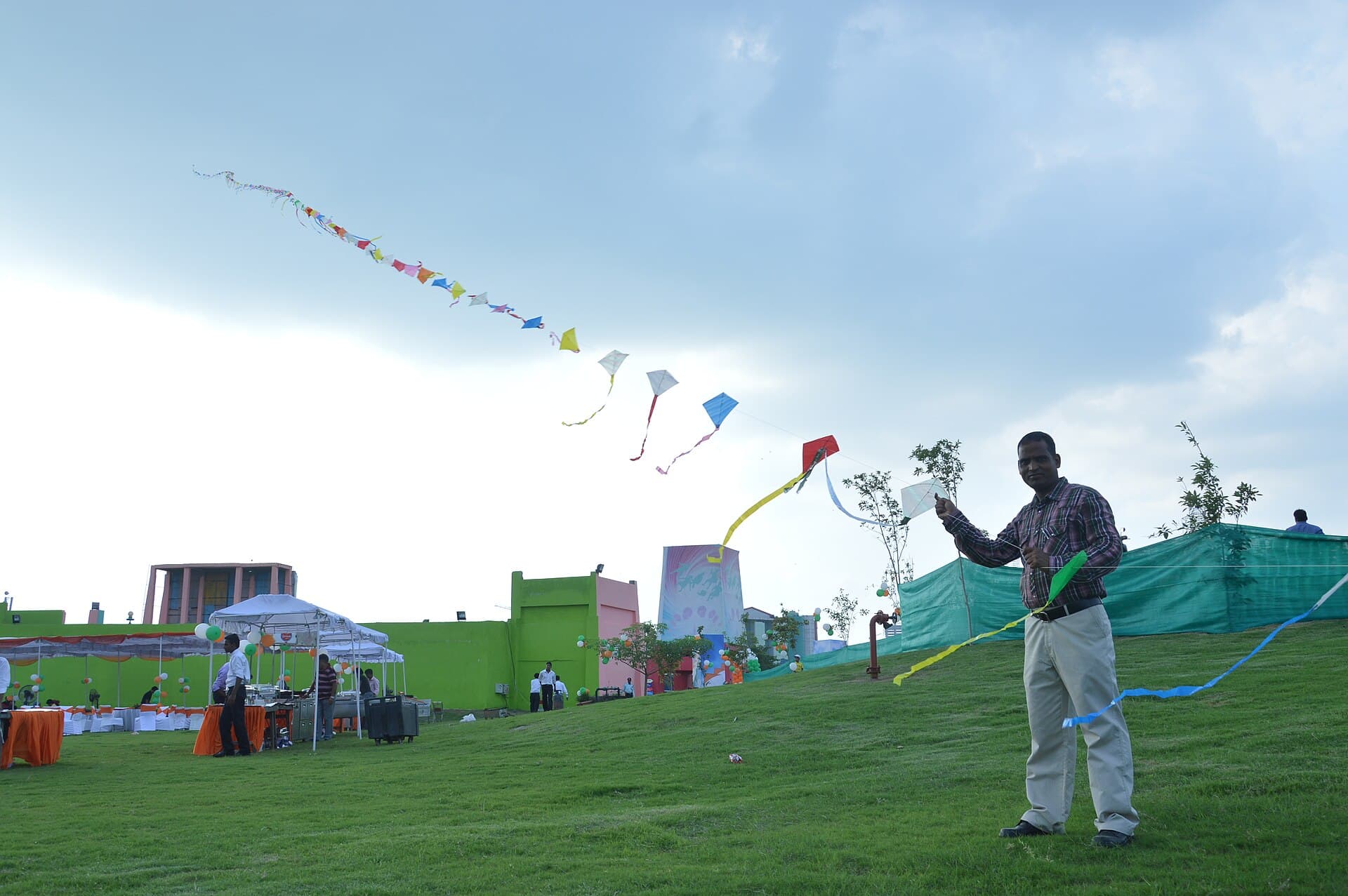 International kite flyers launching giant display kites at the International Kite Festival on the Sabarmati Riverfront in Ahmedabad
