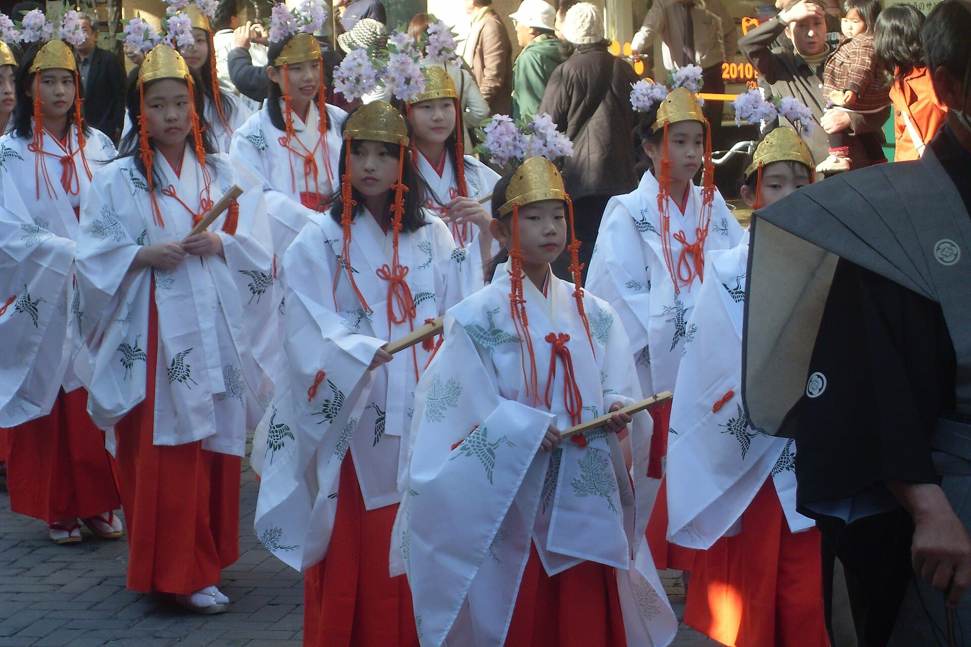 Spring festival procession in costume passing the old town houses of Takayama, Sanno Matsuri