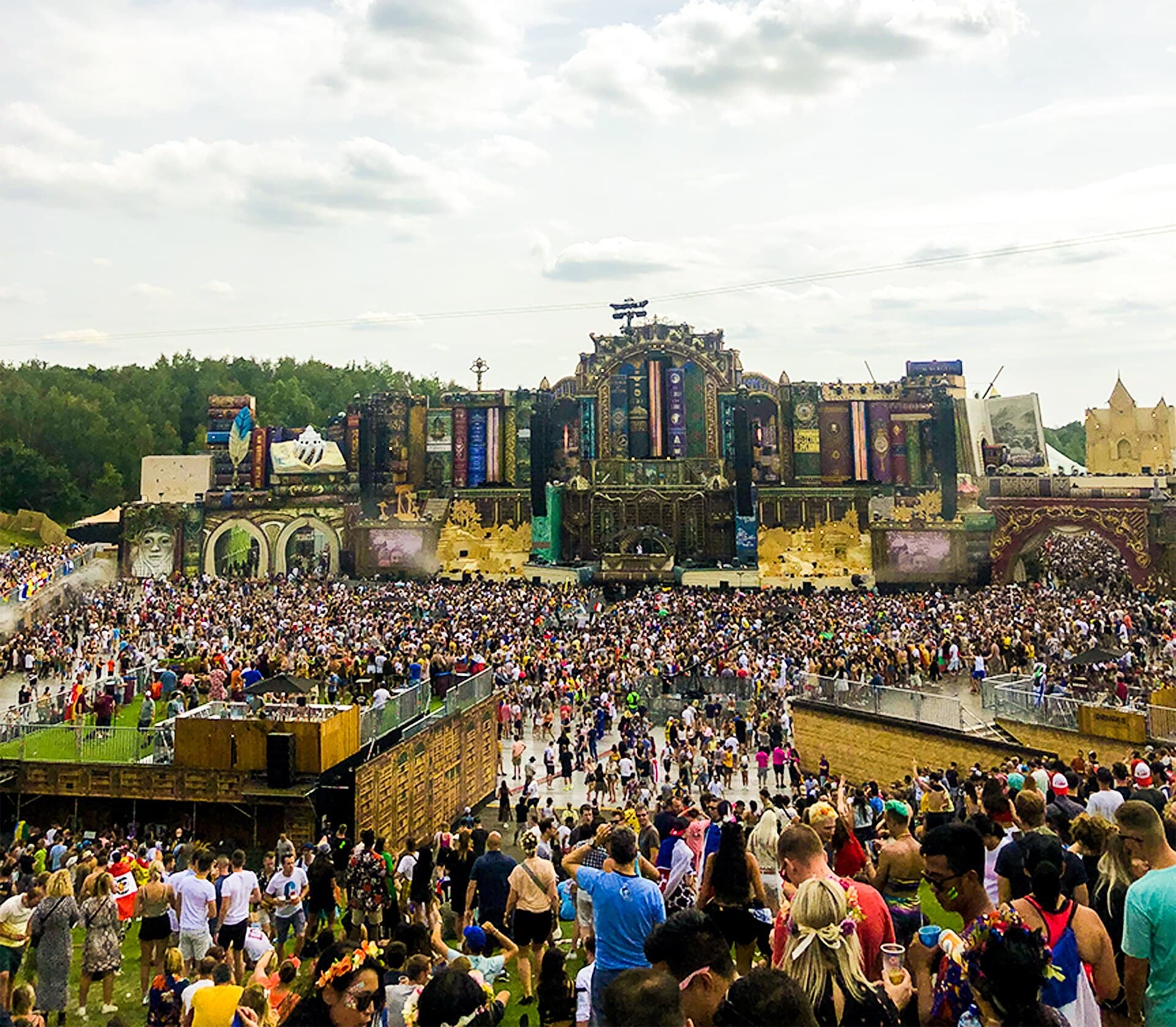 The MainStage interior at Tomorrowland Winter with theatrical stage design and a crowd at night