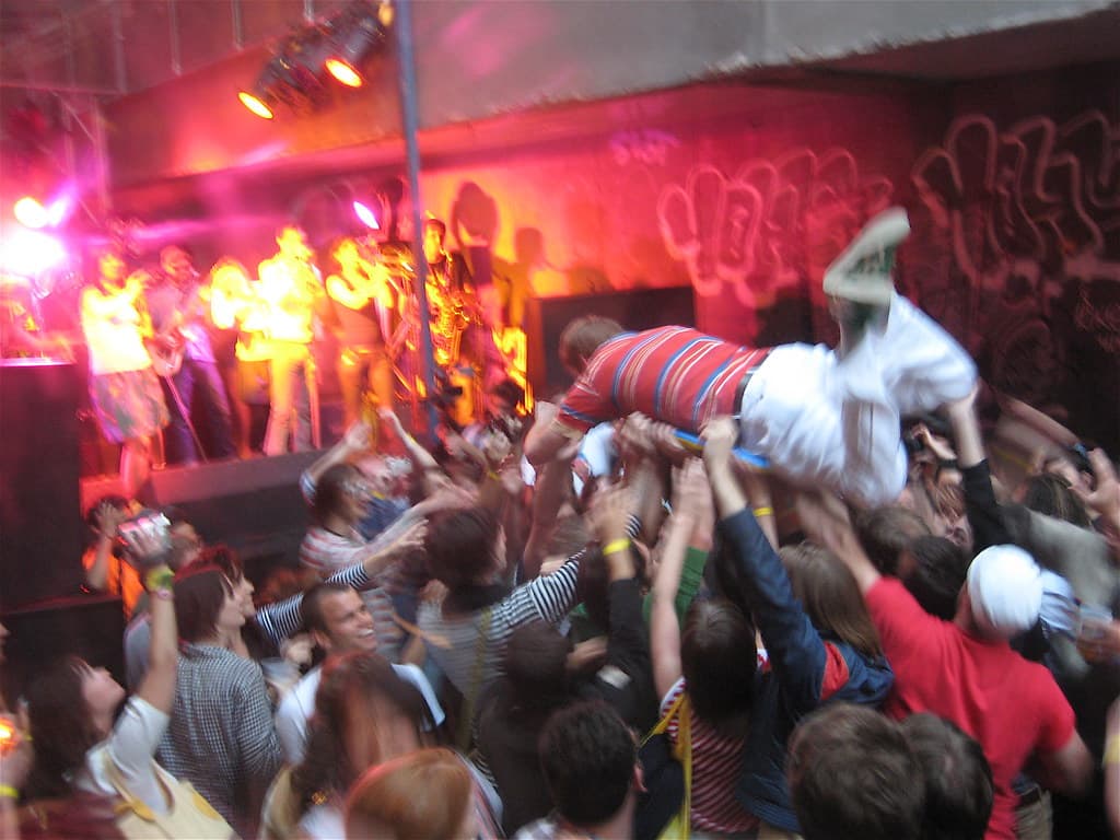 Festival-goers on the VIP viewing platform beside the main stage at Laneway Festival during a daytime set