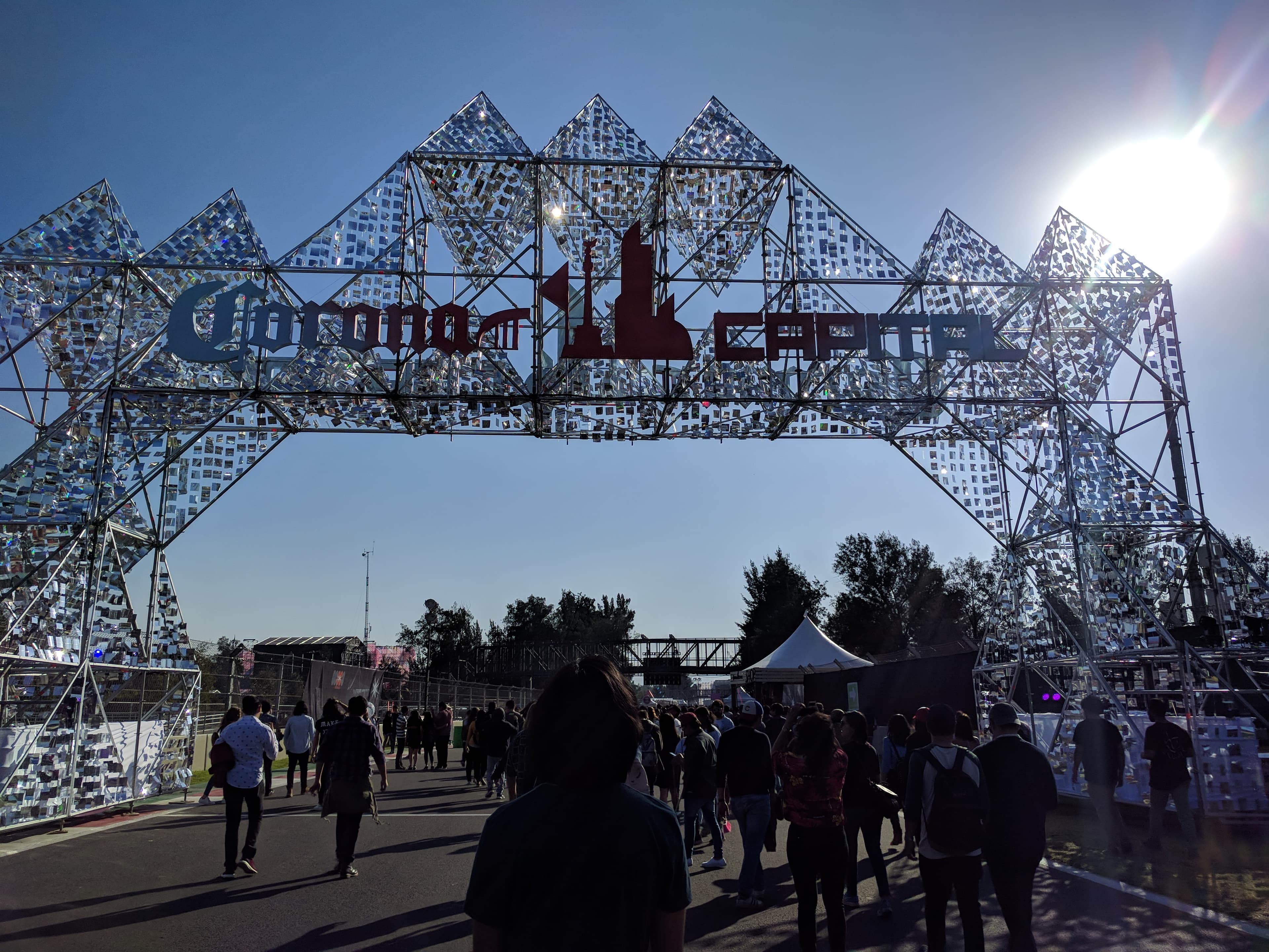 Crowd watching a headliner at night at Corona Capital with the circuit grandstand in the background