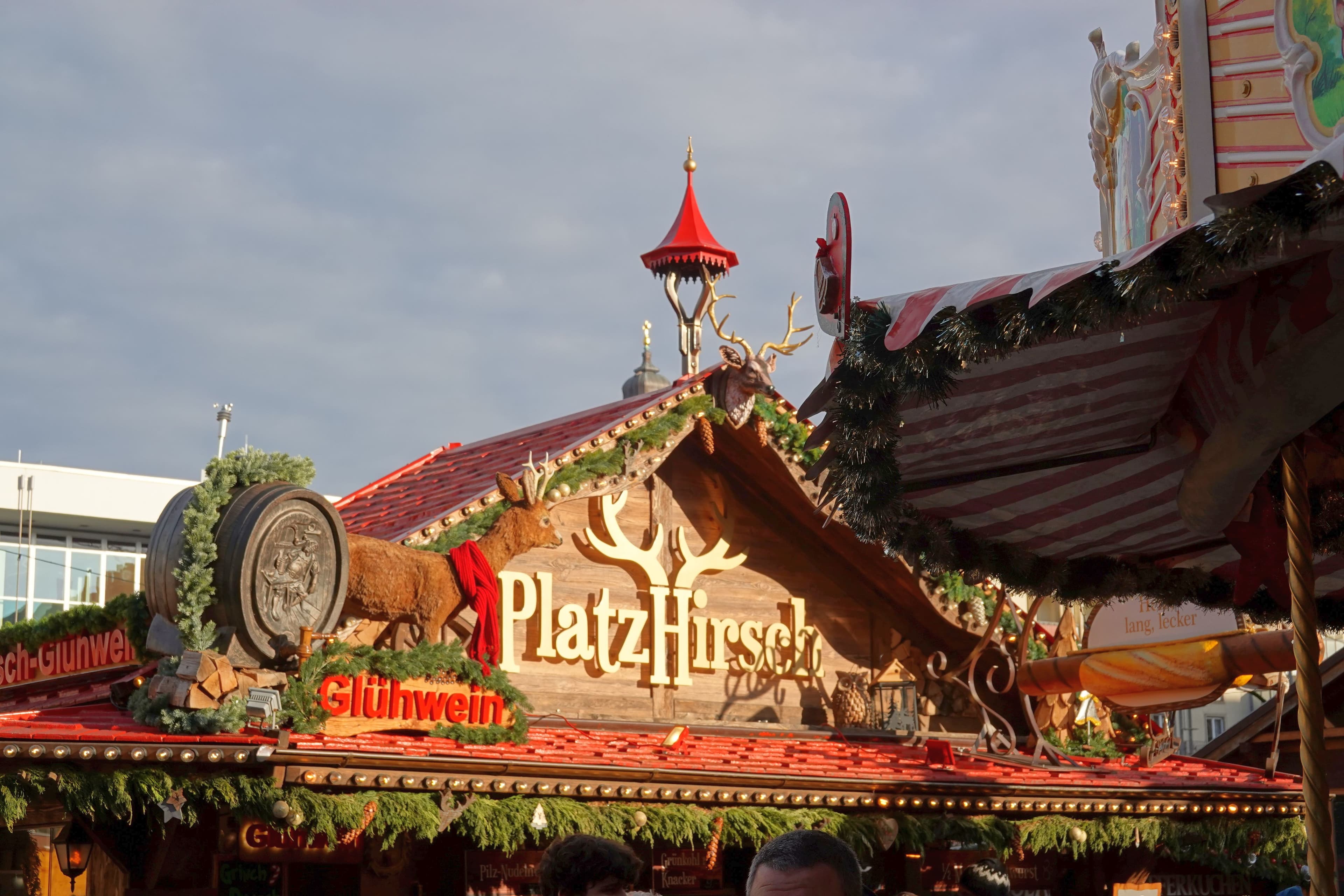 The giant Stollen carried on a wagon through the old town with Stollenmädchen in front