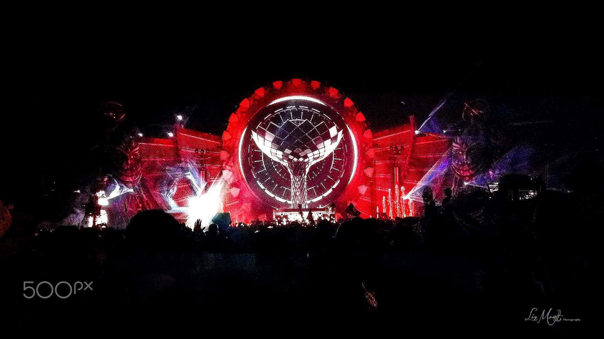 The KineticFIELD main stage lit at night with the circuit's grandstand behind it