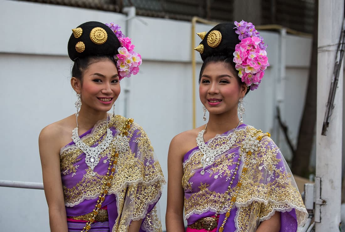 A flower float carrying Miss Flower contestants in Lanna dress passing Tha Phae Gate