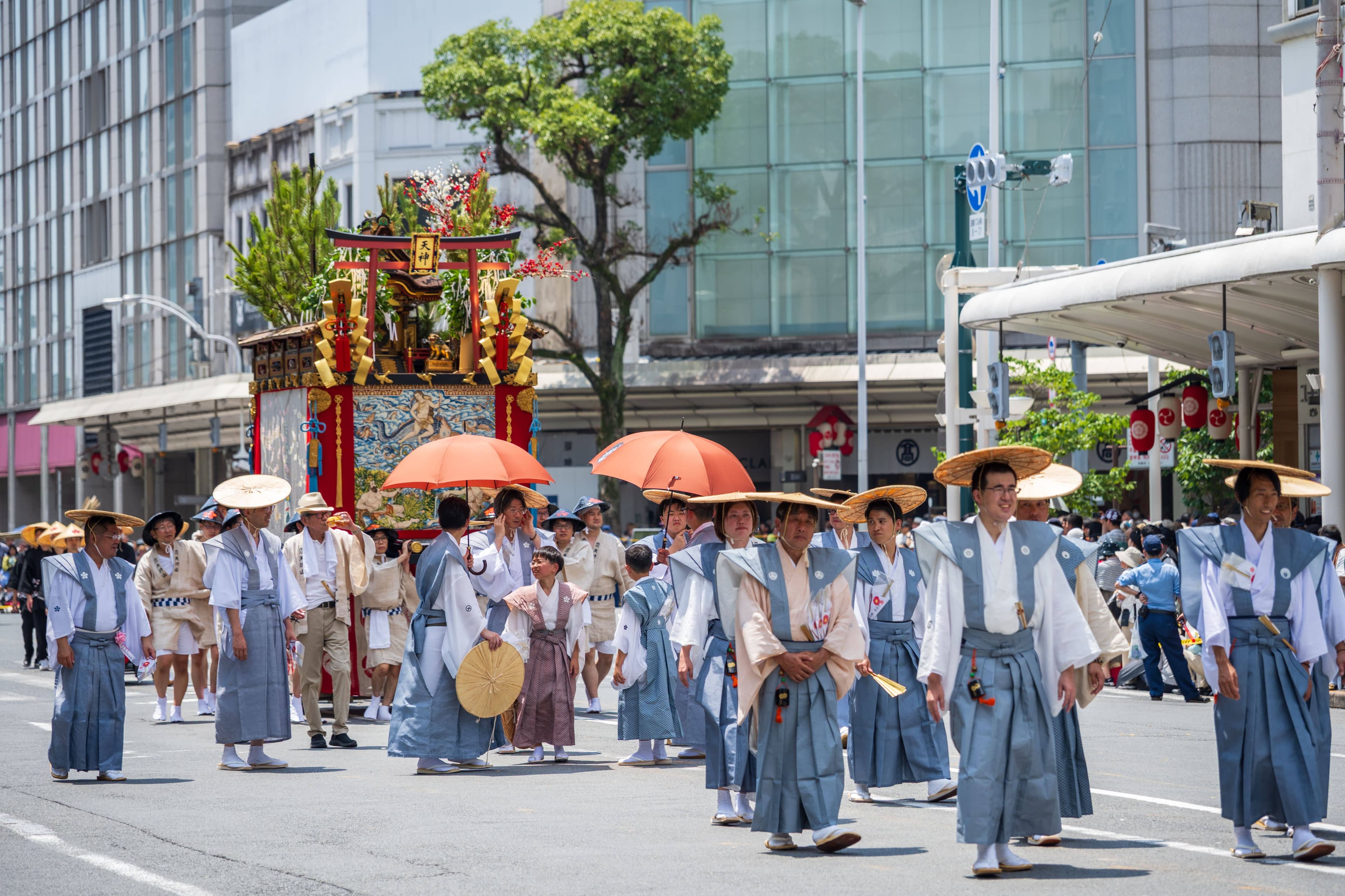 The towering Naginata-hoko float leading the Yamaboko Junko procession along Shijo Street in Kyoto with crowds on both pavements