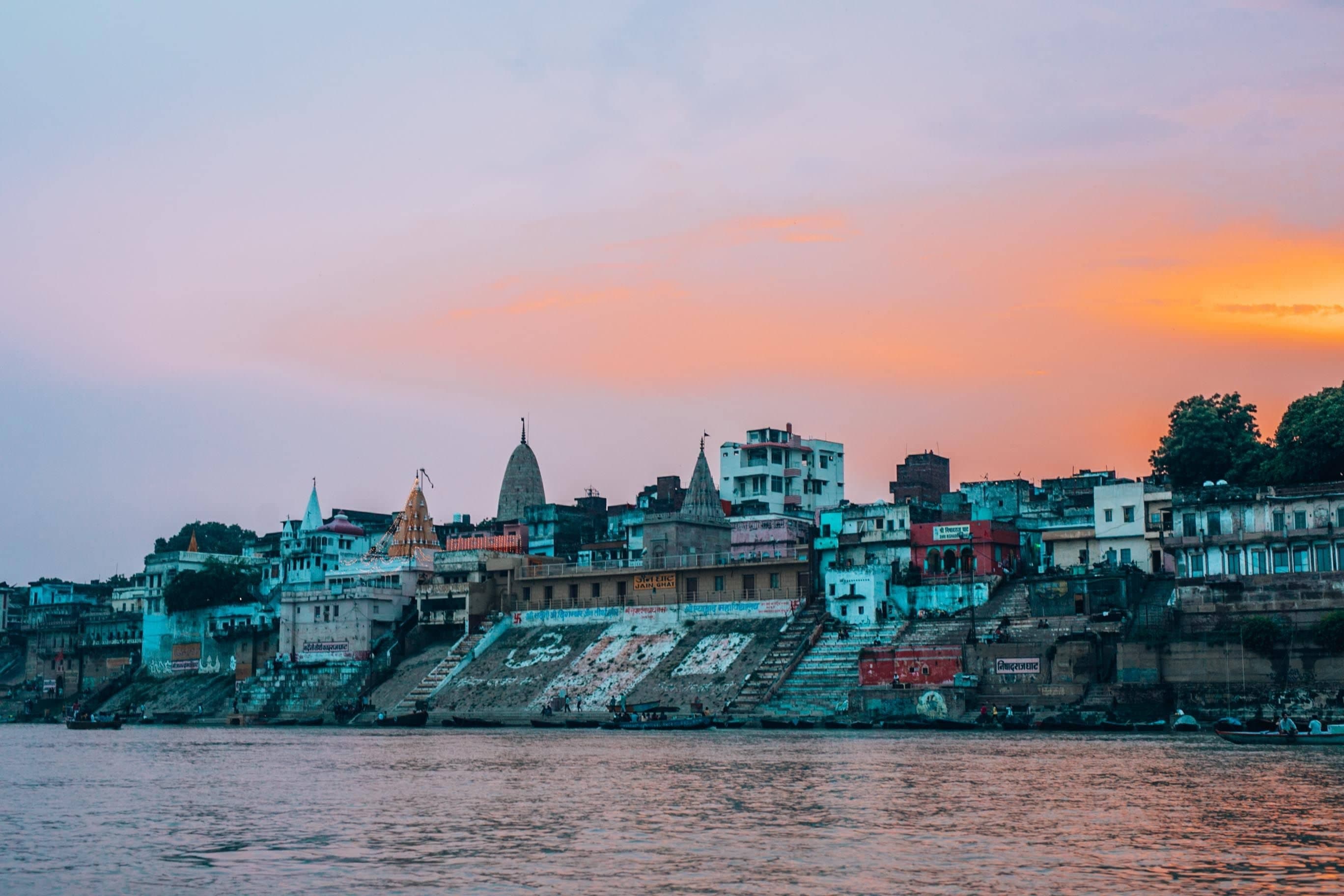 Visitors in shawls watching the Ganga Aarti on a cool November evening at Assi Ghat