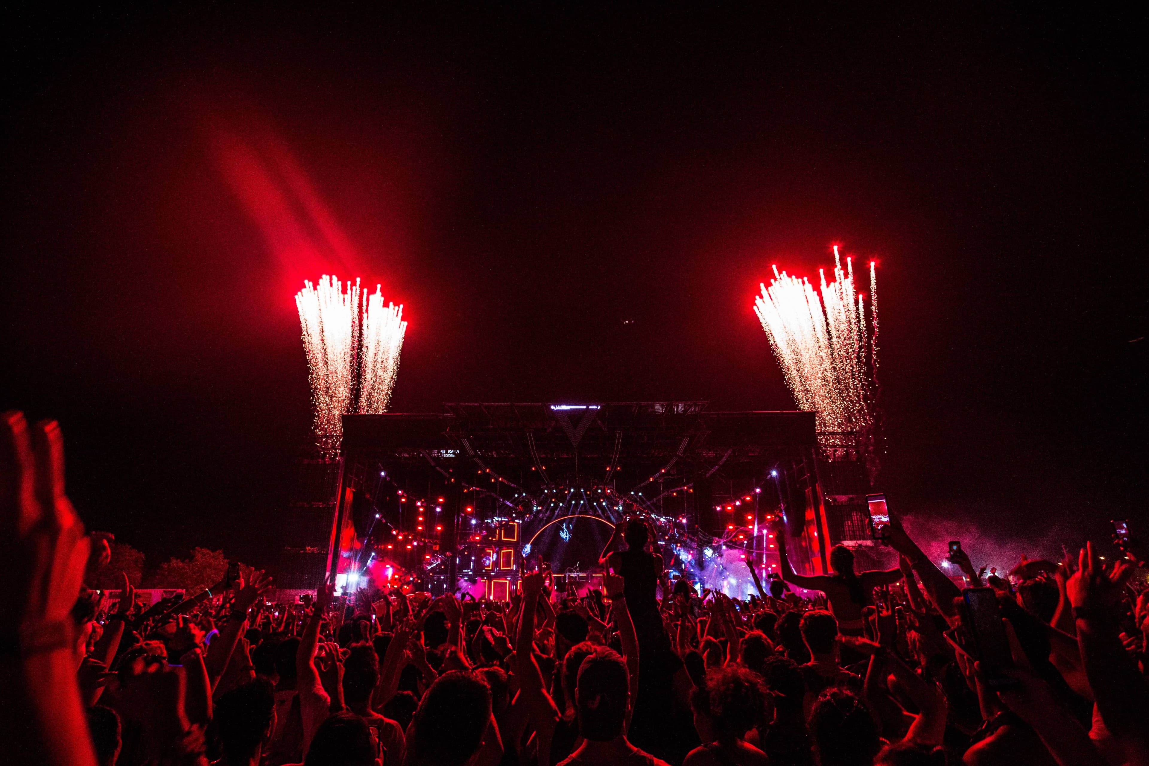 Festival-goers queuing at the Tinker Field entrance lanes at EDC Orlando in the afternoon, wristbands on