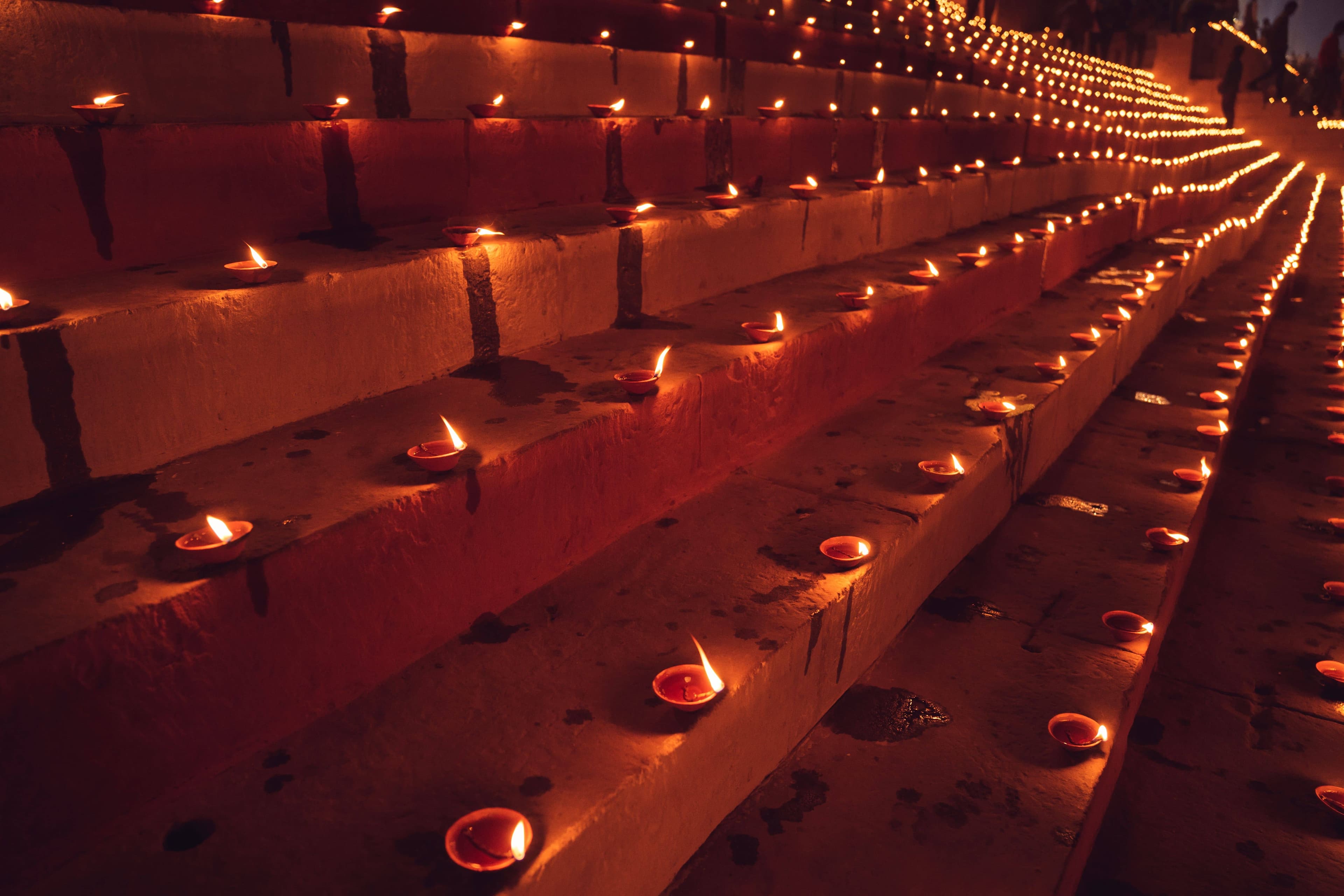 Priests with brass lamps performing the Ganga Aarti on the platforms of Dashashwamedh Ghat